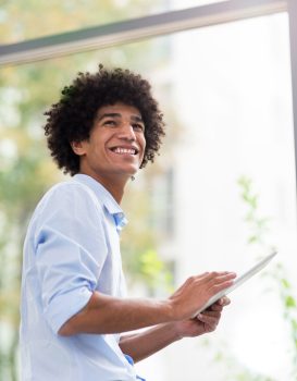 Man with afro holding digital tablet